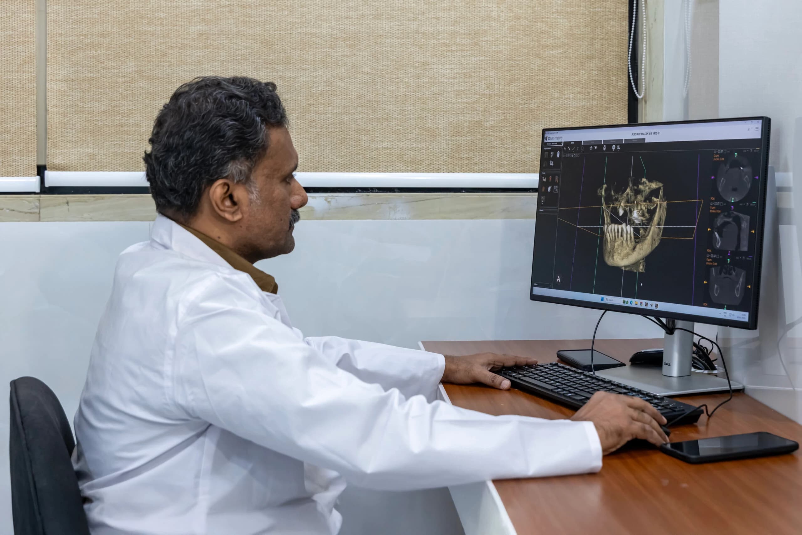 Radiologist reviewing scans at the workstation